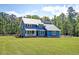 Charming two-story blue home with metal roof and inviting front porch at 2102 Williams Rd, Ruffin, SC 29475