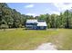Beautiful two-story blue home on a lush lot with a metal roof at 2102 Williams Rd, Ruffin, SC 29475