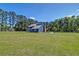 Exterior view of a large home with a spacious yard and trees at 2102 Williams Rd, Ruffin, SC 29475