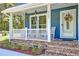 Inviting front porch with rocking chairs and decorative details at 2102 Williams Rd, Ruffin, SC 29475