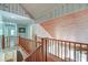 Hallway with wood floors and railing leading upstairs at 2102 Williams Rd, Ruffin, SC 29475