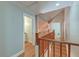 Hallway with wood floors and railing showcases natural wood trim at 2102 Williams Rd, Ruffin, SC 29475