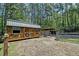 Wooden structure near fenced-in horse area, surrounded by towering trees, providing shade at 2102 Williams Rd, Ruffin, SC 29475