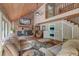 Spacious living room with a brick fireplace, wooden ceilings and floors and comfortable furnishings at 2102 Williams Rd, Ruffin, SC 29475