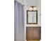 Bathroom featuring a vanity with granite countertop, framed mirror, and shower with curtain at 2159 Spoleto Ln # E, North Charleston, SC 29406