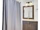 Bathroom featuring a vanity with granite countertop, framed mirror, and shower with curtain at 2159 Spoleto Ln # E, North Charleston, SC 29406