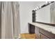 Bathroom with granite countertops, large mirror with vanity lighting, and shower featuring privacy curtain at 2159 Spoleto Ln # E, North Charleston, SC 29406