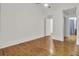 Bright bedroom featuring hardwood floors, white walls, and a connecting doorway at 2159 Spoleto Ln # E, North Charleston, SC 29406