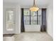 Cozy dining area featuring large windows with gray curtains and access to the deck at 2159 Spoleto Ln # E, North Charleston, SC 29406