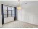 Bright dining room with large window, modern light fixture, and decorative wainscoting at 2159 Spoleto Ln # E, North Charleston, SC 29406