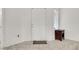 Bright entryway with a white door, tiled floor, and dark wood side table at 2159 Spoleto Ln # E, North Charleston, SC 29406