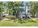 Back exterior of home features large fenced in yard with mature trees and landscaping at 2159 Spoleto Ln # E, North Charleston, SC 29406