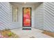 A charming red front door with sidelight and 'hello' welcome mat invites you inside at 2159 Spoleto Ln # E, North Charleston, SC 29406