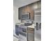 Modern kitchen with stainless appliances, dark wood cabinets, and white countertops at 2159 Spoleto Ln # E, North Charleston, SC 29406
