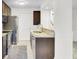 Gourmet kitchen with stainless steel appliances, marble countertops, and tile floors at 2159 Spoleto Ln # E, North Charleston, SC 29406