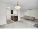 Open floor plan with tiled flooring, modern light fixture and an eat-in bar at 2159 Spoleto Ln # E, North Charleston, SC 29406