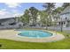Community pool surrounded by green lawn and featuring several lounge chairs at 2159 Spoleto Ln # E, North Charleston, SC 29406