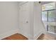 Bright staircase with hardwood floors and a large arched window provides natural light at 2159 Spoleto Ln # E, North Charleston, SC 29406