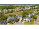 Aerial view of a neighborhood with mature trees, lush green spaces and views of a lake at 2290 Deer Sight Way, Mount Pleasant, SC 29466