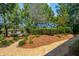 Lush backyard featuring a pergola and seating area, set among mature trees and landscaping at 2290 Deer Sight Way, Mount Pleasant, SC 29466