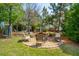 Serene backyard with a stone fire pit, surrounded by chairs, perfect for outdoor entertaining at 2290 Deer Sight Way, Mount Pleasant, SC 29466