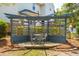 Charming backyard pergola with a seating area, decorative windows, and string lights, creating a cozy outdoor retreat at 2290 Deer Sight Way, Mount Pleasant, SC 29466