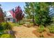 Serene backyard with bench seating area surrounded by lush landscaping and mature trees at 2290 Deer Sight Way, Mount Pleasant, SC 29466