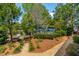 Lush backyard showcasing a landscaped pathway leading to a shaded pergola with seating, perfect for outdoor relaxation at 2290 Deer Sight Way, Mount Pleasant, SC 29466