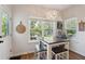 Bright dining area with a view, featuring a modern table with seating for four near an exterior door at 2290 Deer Sight Way, Mount Pleasant, SC 29466