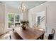 Elegant dining room featuring wainscoting, light blue ceiling and a grand dining table at 2290 Deer Sight Way, Mount Pleasant, SC 29466