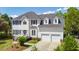 Beautiful two-story home featuring a two-car garage, manicured lawn and mature trees at 2290 Deer Sight Way, Mount Pleasant, SC 29466
