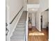 Bright foyer featuring hardwood floors, staircase and stylish lighting fixtures at 2290 Deer Sight Way, Mount Pleasant, SC 29466