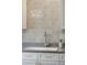 This kitchen features a tiled backsplash, stainless steel faucet, and light countertops at 2290 Deer Sight Way, Mount Pleasant, SC 29466