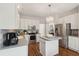 Modern kitchen with a center island, stainless appliances, and stylish white cabinets at 2290 Deer Sight Way, Mount Pleasant, SC 29466