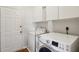 Clean laundry room with a washer, dryer, storage cabinets, and an exterior door at 2290 Deer Sight Way, Mount Pleasant, SC 29466