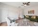 Well-lit living room with green sofa, a ceiling fan, stylish decor and hardwood floors at 2290 Deer Sight Way, Mount Pleasant, SC 29466