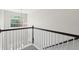 Elegant staircase featuring white railings, a dark wood banister, and a decorative chandelier near a window at 2290 Deer Sight Way, Mount Pleasant, SC 29466