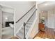 Carpeted staircase featuring hardwood floors and a stylish foyer with an antique sideboard at 2290 Deer Sight Way, Mount Pleasant, SC 29466