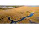 Breathtaking aerial view of a winding river, marshland, community, and boardwalk; a natural paradise at 2292 Skyler Dr, Mount Pleasant, SC 29466