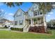 Charming two-story home with light green siding, inviting front porch, and professionally landscaped yard at 2292 Skyler Dr, Mount Pleasant, SC 29466