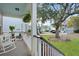 Cozy front porch with rocking chairs, hanging plants, and views of the neighborhood street at 2292 Skyler Dr, Mount Pleasant, SC 29466