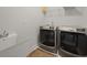 Bright laundry room features a utility sink and modern Maytag washer and dryer set at 2292 Skyler Dr, Mount Pleasant, SC 29466