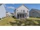 The backyard features a screened-in porch and ample green space with a well-manicured lawn at 234 Daniels Creek Cir, Goose Creek, SC 29445