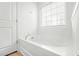 Neutral bathroom showcasing a stand alone tub with a large window at 234 Daniels Creek Cir, Goose Creek, SC 29445