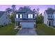 Charming two-story home with stone accents, well-maintained lawn, and an attached two-car garage at 234 Daniels Creek Cir, Goose Creek, SC 29445