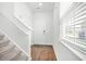 Bright foyer with hardwood floors, staircase, and a view of the front door with security features at 234 Daniels Creek Cir, Goose Creek, SC 29445