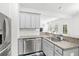 Kitchen features stainless steel appliances, granite countertops, white cabinets, and modern fixtures at 234 Daniels Creek Cir, Goose Creek, SC 29445
