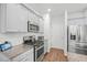 Kitchen features stainless steel appliances, granite countertops, white cabinets, and modern fixtures at 234 Daniels Creek Cir, Goose Creek, SC 29445