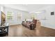 Spacious living room with hardwood floors, ample natural light, and open to the dining area at 234 Daniels Creek Cir, Goose Creek, SC 29445