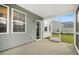 A screened porch provides a seamless transition to the outdoors with a view of the home's exterior at 234 Daniels Creek Cir, Goose Creek, SC 29445